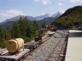 Parc d´Atractions: pracovní vozidla úzkokolejné drážky na pozadí štítů masivu Mont Blanc ve stanici Les Montuires	. 23.8.2011	 © Jan Přikryl