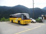 Autobus Neoplan Transliner z poloviny 90. let dopravce Auto Postale stojí odstavený na parkovišti u konečné zastávky Spruga, 27.6.2014 © Jan Přikryl